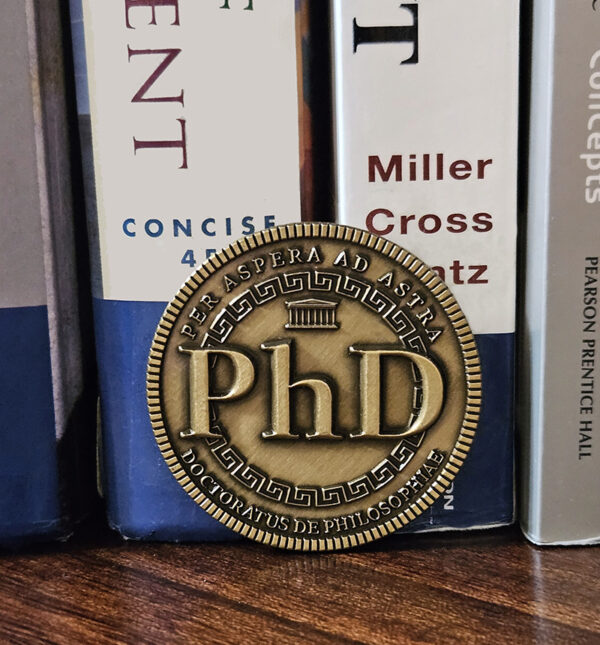 Doctorum's PhD Coin is remarkable tribute and an exceptional gift for the PhD in your life. Whether celebrating a new PhD program graduate or honoring the seasoned Doctor, this unique creation is sure to make a lasting impression.