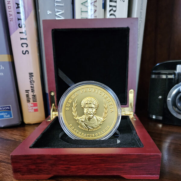 Doctorum's PhD Coin featuring Marcus Aurelius This is indeed a remarkable tribute and an exceptional gift for the PhD in your life. Whether celebrating a new PhD program graduate or honoring the seasoned Doctor, this unique creation is sure to make a lasting impression.